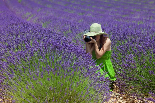 Woman among lavender photographing