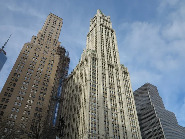 Woolworth Building and Other Architecture in New York against blue sky with cloud cover moving in