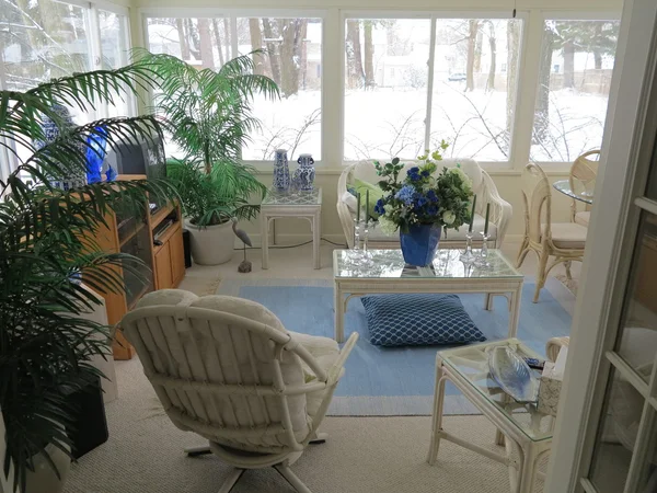 Decorated Florida Room with vase of flowers with fresh white snow in background