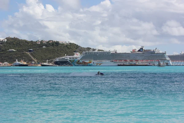 Ocean Liners or Cruise Ships site idle at Little bay in St. Martin while storm front moves thru