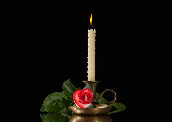 Candle light  with flower on black background