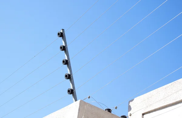 View Of An Electric Fence Installaton On A Concrete Wall