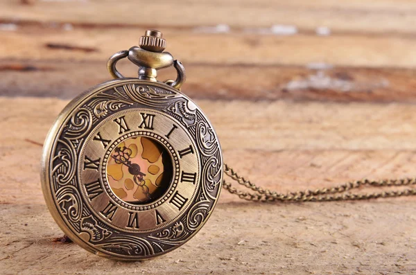 Pocket watch on wooden background