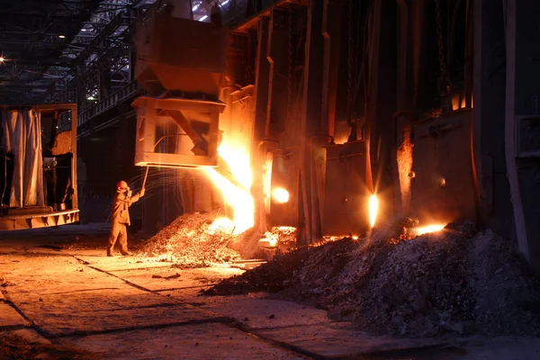 Smelting metal in a metallurgical plant. Liquid iron in the ladl
