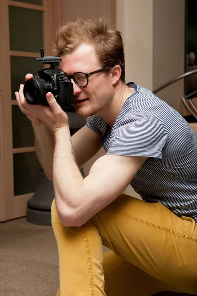 Photographer at work in photographic studio