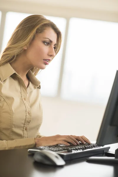 Young Businesswoman Using Desktop PC