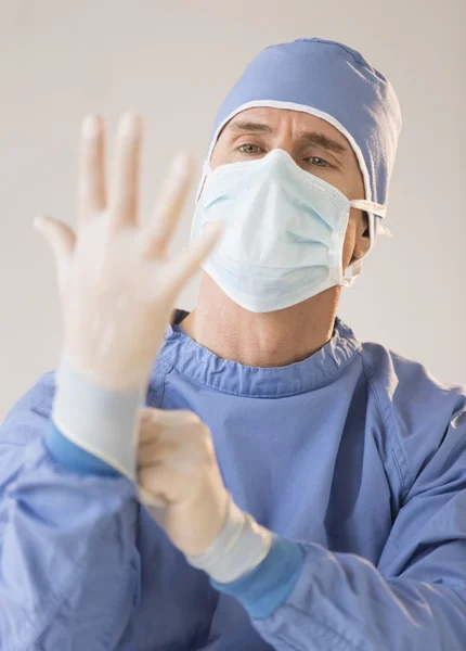 Male Surgeon Wearing Protective Glove