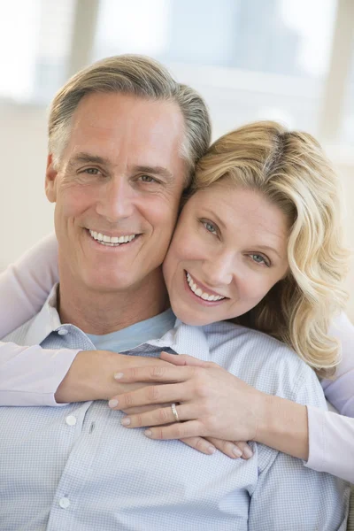 Happy Woman Embracing Man From Behind At Home