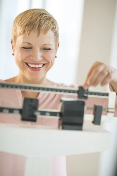Cheerful Woman Using Balance Weight Scale