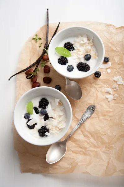 Healthy Paleo Style dessert, Frozen Berries in Coconut Milk with Nuts and Vanilla