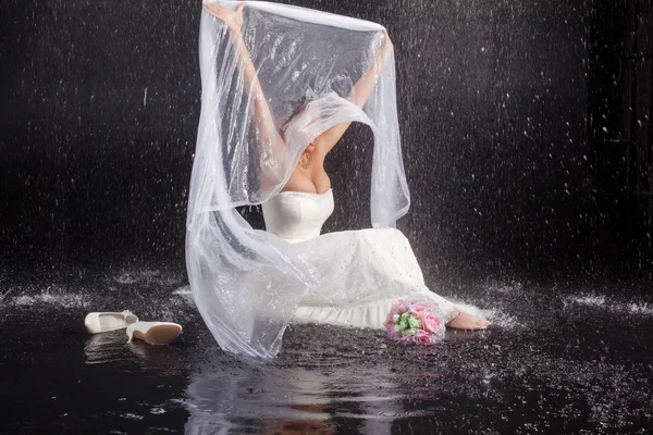 Bride in white dress  in water studio