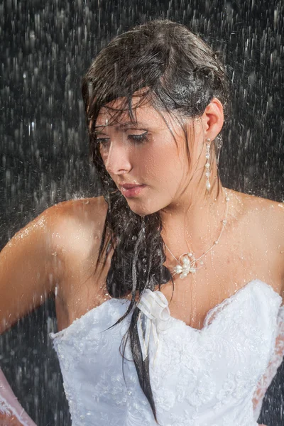 Bride posing under the rain