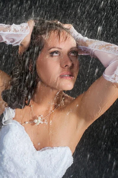 Bride posing under the rain