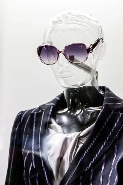 Female translucent mannequin in suit with sunglasses