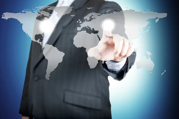 Business man pointing on the touch screen with world map