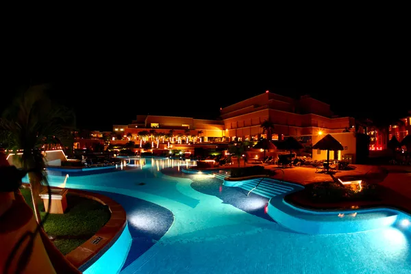 A luxury all inclusive beach resort at night