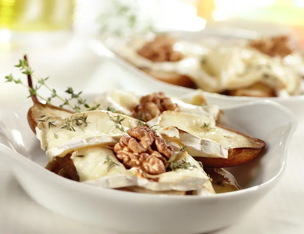 Tasty baked pear with brie honey walnut and thyme