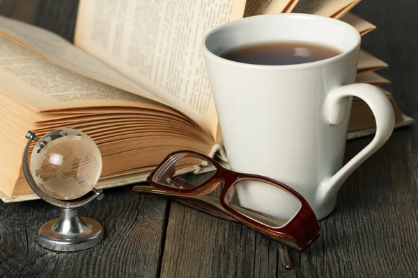 Tea cup, glasses, book, globe