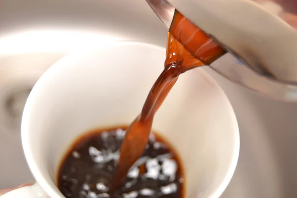 Coffee pouring coffee in a cup
