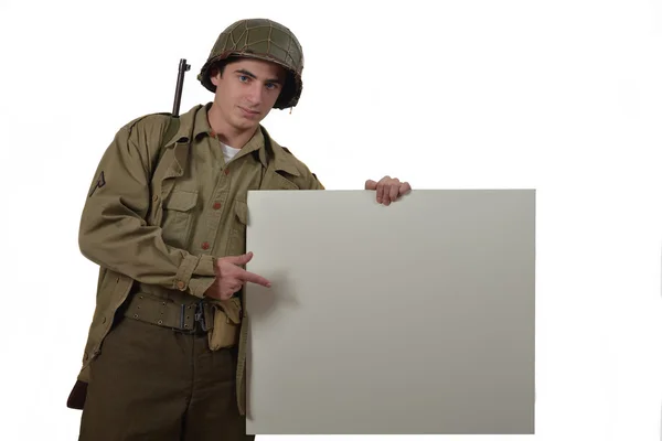 Young American soldier shows a sign