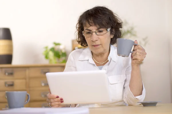 A middle-aged woman using a  computer tablet