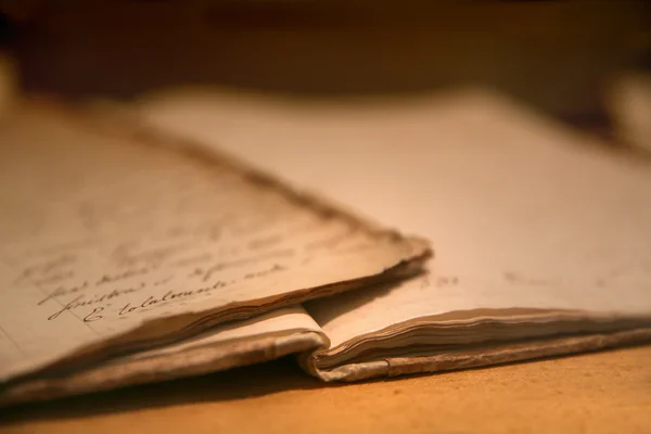 Old handwritten notes in a battered old book-notebook