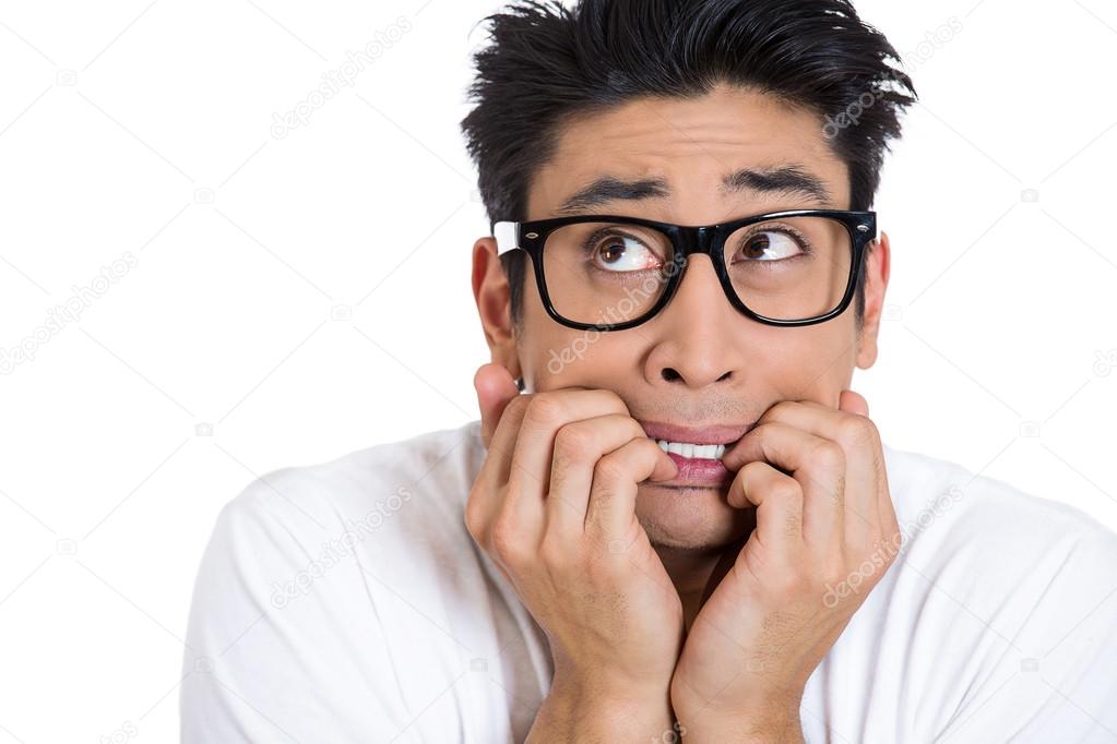 Closeup portrait of nervous, stressed young nerdy guy man with