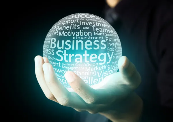 Businessman hand showing business strategy word