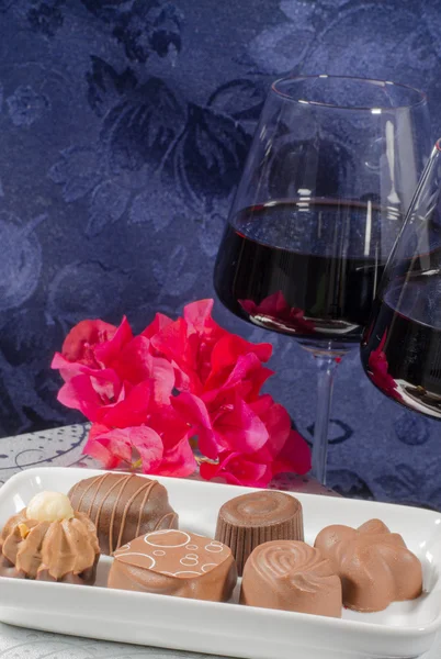 Chocolate flowers red wine glasses