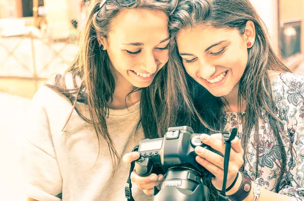 Young girls watching photos in a digital Camera