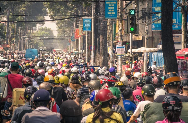 HO CHI MINH CITY, VIETNAM - FEBRUARY 2, 2013: traffic jam with a congestion of scooters and people with colorful helmets. There are approximately 340,000 cars and 3,5 million motorcycles in the city.