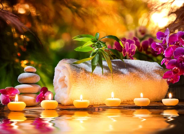 Spa massage in garden - candles and water