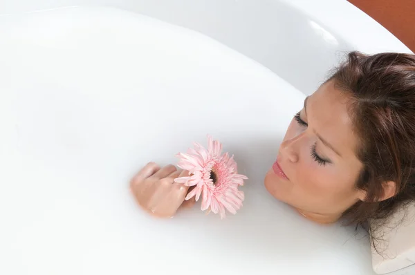 Woman relaxing in milk bath