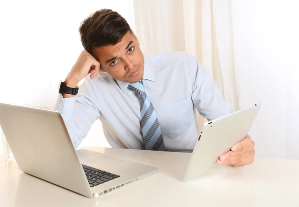 Young depressed Man working at the office with Computer