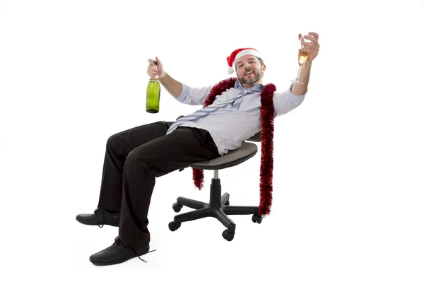Drunk businessman drinking champagne wearing a santa hat on whit