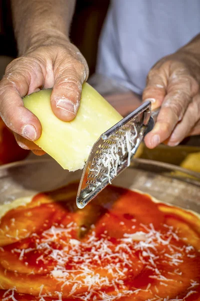 Using a grater to grate cheese