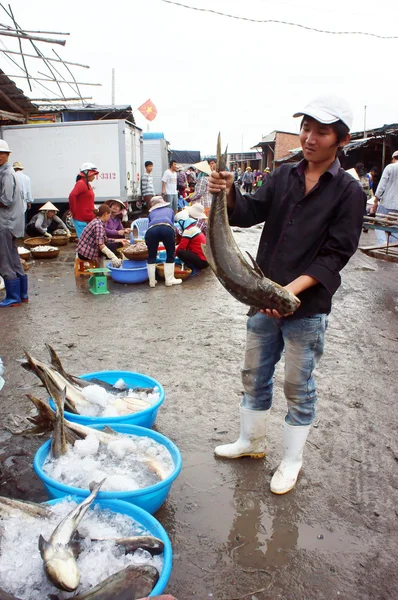 The man hold big fish at fishing market. LONG HAI, VIET NAM- JULY 15