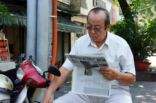 The old man reading newspaper