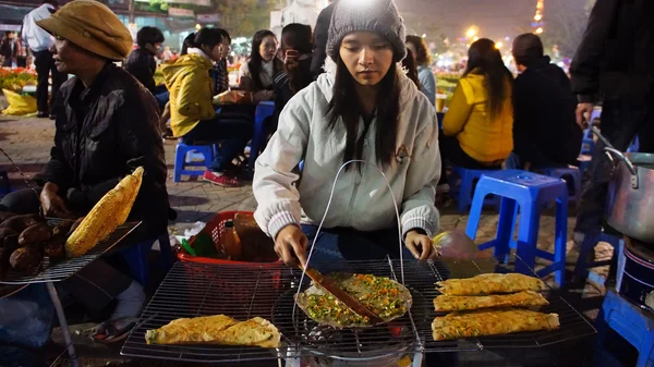 Vietnamese street food vendor at night outdoor market
