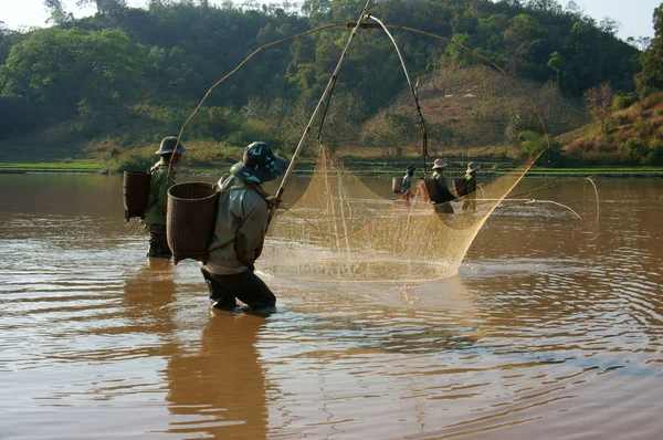 People catch fish by lift net on ditch