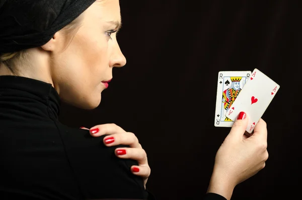 Woman in black with playing cards