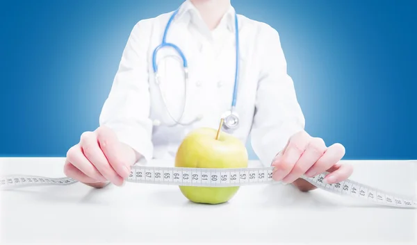 Doctor measures the apple