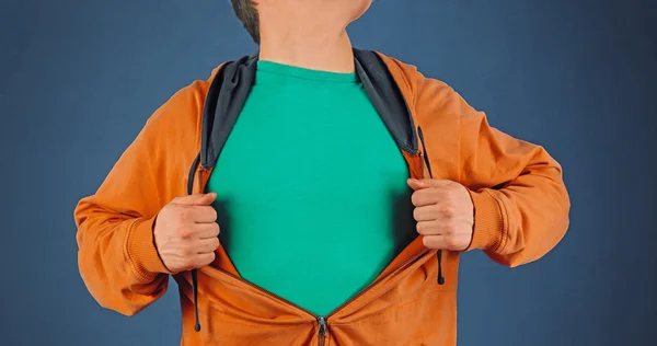Man opens orange shirt, copyspace