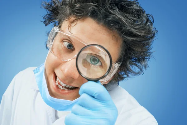 Bizarre scientist looks through a magnifying glass