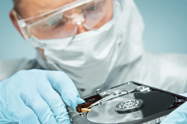 Scientist examines the hard disk