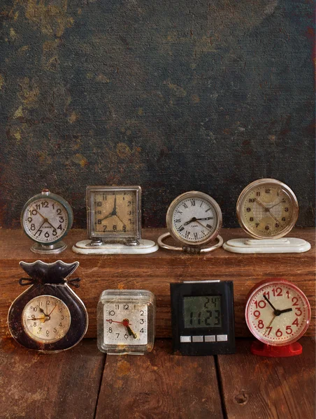 Old clock on a grungy background. Collection of vintage watches