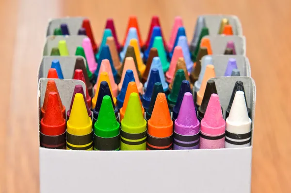 Collection of colorful wax crayons  in boxes