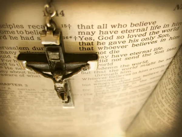 Handmade cross hanging over the Bible