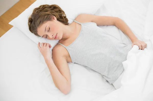 Calm slender woman lying sleeping on her bed