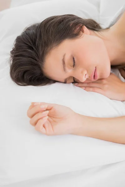 Pretty young woman sleeping in bed